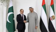 This handout image provided by the UAE Presidential court on January 12, 2023 shows UAE President Sheikh Mohamed bin Zayed al-Nahyan posing for a picture with Shehbaz Sharif, Prime Minister of Pakistan, prior to their meeting, at Al Shati Palace in Abu Dhabi. (Photo by UAE PRESIDENTIAL COURT / AFP)