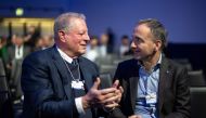 Former US vice-president and climate campaigner Al Gore (L) speaks with Siemens chairman Jim Hagemann Snabe at the Congress centre during the World Economic Forum (WEF) annual meeting in Davos, on January 17, 2022. (Photo by Fabrice COFFRINI / AFP)