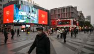 File photo: People walk on a street in Wuhan, in China's central Hubei province, on January 21, 2023. (Photo by Hector RETAMAL / AFP) 