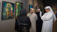 Minister of State and President of Qatar National Library H E Dr. Hamad bin Abdulaziz Al Kawari (right), and Katara General Manager Prof. Dr. Khalid bin Ibrahim Al Sulaiti, along with other officials during the opening of Acrylic Pouring Exhibition 2 at Katara.