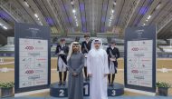 The podium winners of dressage competitions pose with officials during the presentation ceremony.