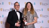 US decorator and production designer Florencia Martin and Anthony production designer Anthony Carlino pose with the award for Best production design for 'Babylon' during the BAFTA British Academy Film Awards ceremony at the Royal Festival Hall, Southbank Centre, in London, on February 19, 2023. (Photo by JUSTIN TALLIS / AFP)