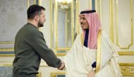 This handout picture taken and released by the Ukrainian Presidential press service on February 26, 2023, shows Ukrainian President Volodymyr Zelensky (L) shaking hands with Foreign Minister of the Kingdom of Saudi Arabia Prince Faisal bin Farhan Al Saud (R) prior to their talks in Kyiv. (Photo by Handout / Ukrainian Presidential Press Service / AFP)