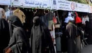 People shop at an exhibition of local products in the rebel-held Yemeni capital Sanaa, on February 27, 2023. (Photo by Mohammed Huwais / AFP)