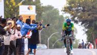 Cycling spectators cheer on as Jean Bosco Nsengimana (R) rides in a solo breakaway during stage 3 of the Tour du Rwanda from Huye to Musanze, on February 21, 2023. Photo by AFP