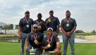 Team Qatar golfers pose with their trophies.