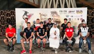 QMMF’s Executive Director Amro Al Hamad with drivers and riders during a press conference, yesterday.