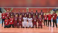 Qatar volleyball team players and officials pose for a photograph. 