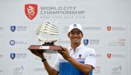 This handout photo taken and released by the Asian Tour on March 26, 2023 shows Hong Kong's Taichi Kho posing with the winner's trophy during round three of the World City Championship presented by the Hong Kong Golf Club. Photo by Paul LAKATOS / Asian Tour / AFP