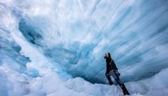 File Photo: Glaciologist Martin Stocker-Waldhuber from the Austrian Academy of Sciences explores a natural glacier cavity of the Jamtalferner glacier near Galtuer, Austria, October 15, 2021. 