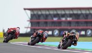 KTM South African rider Brad Binder (right), Aprilia Spanish rider Maverick Vinales (centre), and Ducati Italian rider Francesco Bagnaia ride during a practice session of the MotoGP Argentina Grand Prix at the Termas de Rio Hondo circuit in Santiago del Estero, Argentina on March 31, 2023. (Photo by JUAN MABROMATA / AFP)