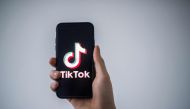 In this file illustration photo taken on January 21, 2021 in Nantes, western France, a man shows a smartphone with the logo of Chinese social network Tik Tok. Photo by LOIC VENANCE / AFP