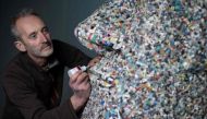 Artist and environmental activist Rob Arnold, works on a sculpture called 