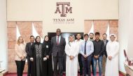 US Ambassador to Qatar H E Timmy T Davis poses with Texas A&M University students and faculty.