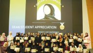 The students pose for photograph during the honouring ceremony at the Qatar University, recently.