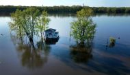 In this aerial, a home is surrounded by floodwater from the Mississippi River on May 03, 2023 in Albany, Illinois. Scott Olson/Getty Images/AFP 