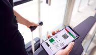 Close up of a passenger in airport looking at digital boarding pass on smart phone. Source: Emirates website 