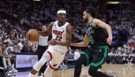 Jimmy Butler #22 of the Miami Heat drives against Derrick White #9 of the Boston Celtics during the third quarter in game three of the Eastern Conference Finals at Kaseya Center on May 21, 2023 in Miami, Florida. Photo by Megan Briggs / GETTY IMAGES NORTH AMERICA / Getty Images via AFP