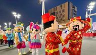 Performers parade during Darb Lusail Flower Festival.