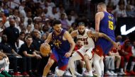 Jamal Murray #27 of the Denver Nuggets dribbles past a screen set by Nikola Jokic #15 against Caleb Martin #16 of the Miami Heat during the fourth quarter in Game Three of the 2023 NBA Finals at Kaseya Center on June 07, 2023 in Miami, Florida.  Photo by Mike Ehrmann /  Getty Images via AFP)
