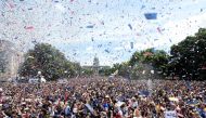 Confetti flies over the crowd during the Denver Nuggets victory parade and rally after winning the 2023 NBA Championship at Civic Center Park on June 15, 2023 in Denver, Colorado. (Photo by Matthew Stockman / Getty Images via AFP)