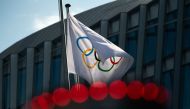 This file photo taken on March 8, 2021 shows the Olympic flag next to the headquarters of the International Olympic Committee (IOC) in Lausanne. (Photo by Fabrice Coffrini / AFP)