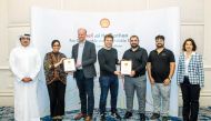 TAMUQ students and officials with the award.