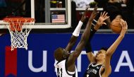 Portland Trail Blazers' Ibou Badji (L) fails to block a point by San Antonio Spurs' Victor Wembanyama (R) during the NBA Summer League game between the San Antonio Spurs and Portland Trail Blazers, at the Thomas and Mack Center in Las Vegas, Nevada, on July 9, 2023. (Photo by Patrick T. Fallon / AFP)