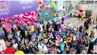 People enjoying the dropping of balloons during the opening of Qatar Toy Festival at the DECC.