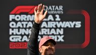 Pole position winner Mercedes' British driver Lewis Hamilton waves to fans after the qualifying session at the Hungaroring race track in Mogyorod near Budapest on July 22, 2023, ahead of the Formula One Hungarian Grand Prix. (Photo by ATTILA KISBENEDEK / AFP)
