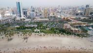 This aerial picture shows people at the beach to escape the heat in Kuwait City on July 7, 2023. (Photo by Yasser Al-Zayyat / AFP)