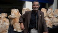 Peruvian paleontologist Mario Urbina poses next to the fossilized remains of the Perucetus colossus at the Natural History Museum in Lima on August 2, 2023. (Photo by Cris Bouroncle / AFP)