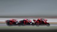 Eventual race winner, Aprilia Racing Spanish rider Aleix Espargaro (C) is sandwiched between Aprilia Racing Spanish rider Maverick Vinales (L) and Ducati Lenovo Team Italian rider Francesco Bagnaia (R) during the Moto GP race of the motorcycling British Grand Prix at Silverstone circuit in Northamptonshire, central England, on August 6, 2023. (Photo by Ben Stansall / AFP)
