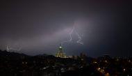 A picture taken on August 22, 2023 shows lightning over Makkah's clock tower in Saudi Arabia. Photos by Hammad Al-Huthali / AFP