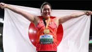 Gold medalist, Japan's Haruka Kitaguchi celebrates with her National flag and gold medal after winning the women's javelin throw final during the World Athletics Championships at the National Athletics Centre in Budapest on August 25, 2023. (Photo by Kirill Kudryavtsev / AFP)