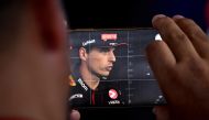 Red Bull Racing's Dutch driver Max Verstappen speaks during an interview as someone photographs him on a mobile phone at the Monza Circuit ahead of the Italy's Formula One Grand Prix, in Monza northern Italy, on August 31, 2023. Photo by Ben Stansall / AFP