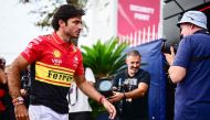 Ferrari's Spanish driver Carlos Sainz Jr (L) arrives prior to the third practice session in Monza on September 2, 2023. (Photo by Ben Stansall / AFP)
