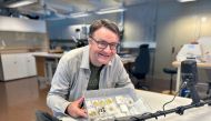 Handout photo released on September 7, 2023, by the Museum of Archaeology and the University of Stavanger (UiS) shows amateur archaeologist Erlend Bore posing with gold treasure in Stavanger. (Photo by Anniken Celine Berger / various sources / AFP) 