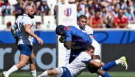 Namibia's lock Tjiuee Uanivi (CR) is tackled by Italy's flanker and captain Michele Lamaro (CL) during the France World Cup 2023 Pool A match between Italy and Namibia at Stade Geoffroy-Guichard in Saint-Etienne, south-eastern France on September 9, 2023. (Photo by Olivier CHASSIGNOLE / AFP)
