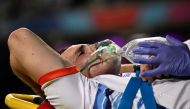 A medical official assists Namibia's inside center Le Roux Malan as he is moved from the pitch after suffering an injury during the France 2023 Rugby World Cup Pool A match between New Zealand and Namibia at Stadium de Toulouse in Toulouse, south-western France on September 15, 2023. (Photo by Lionel BONAVENTURE / AFP)
