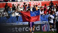 A Samoan player waves the Samoan flag after winning the France 2023 Rugby World Cup Pool D match between Samoa and Chile at Stade de Bordeaux in Bordeaux, south-western France on September 16, 2023. (Photo by Christophe ARCHAMBAULT / AFP)
