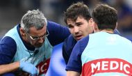 France's scrum-half and captain Antoine Dupont (C) receives medical attention during the France 2023 Rugby World Cup Pool A match between France and Namibia. (Photo by Christophe Simon / AFP)