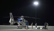 Crews move one of the helicopters that will participate in the Osiris-Rex asteroid sample return recovery mission out of a hanger at Dugway, Utah early September 24, 2023. (Photo by George Frey / AFP)