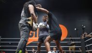 Cameroonian-French mixed martial arts star and boxer Francis Ngannou (C) watches as Dewey Cooper spars with former US boxer Mike Tyson (R) during a training session at Ngannou痴 gym in Las Vegas, Nevada, on September 26, 2023. (Photo by Ian Maule / AFP)
