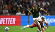 South Africa's wing Makazole Mapimpi (L) fights for the ball with Tonga's wing Fine Inisi (R) during the France 2023 Rugby World Cup Pool B match between South Africa and Tonga at Stade Velodrome in Marseille, south-eastern France, on October 1, 2023. (Photo by CHRISTOPHE SIMON / AFP)
