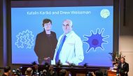 A screen at the Karolinska Institute shows this year's laureates Katalin Kariko of Hungary (L) and Drew Weissman of the US during the announcement of the winners of the 2023 Nobel Prize in Physiology or Medicine at the Karolinska Institute in Stockholm on October 2, 2023. (Photo by Jonathan NACKSTRAND / AFP)
