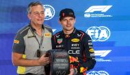 Red Bull Racing's Dutch driver Max Verstappen is awarded the Pole Position trophy after the qualifying session ahead of the Qatari Formula One Grand Prix at the Lusail International Circuit on October 6, 2023. (Photo by Giuseppe Cacace / AFP)