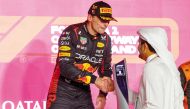 Qatar Olympic Committee President H E Sheikh Joaan bin Hamad Al Thani presents the winner's trophy to Red Bull Racing’s Dutch driver Max Verstappen following the Formula 1 Qatar Airways Qatar Grand Prix 2023, at the Lusail International Circuit, yesterday. AFP