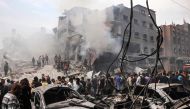 Palestinians search for survivors after an Israeli airstrike on buildings in the refugee camp of Jabalia in the Gaza Strip yesterday.