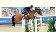 Team NK Cafe's Saeed Nasser Al Qadi guides Carrera Denfer over a fence during the Medium Tour Team event.